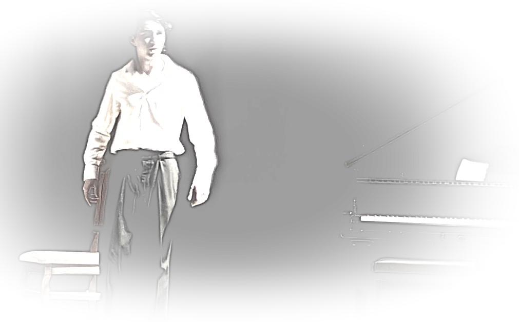 Alone on a stage beside a grand piano