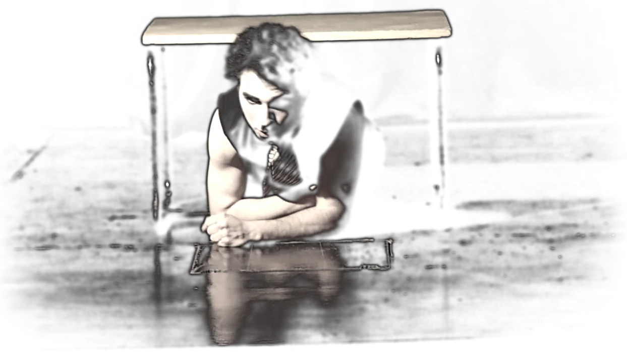 Lying beneath a table on a dark stage